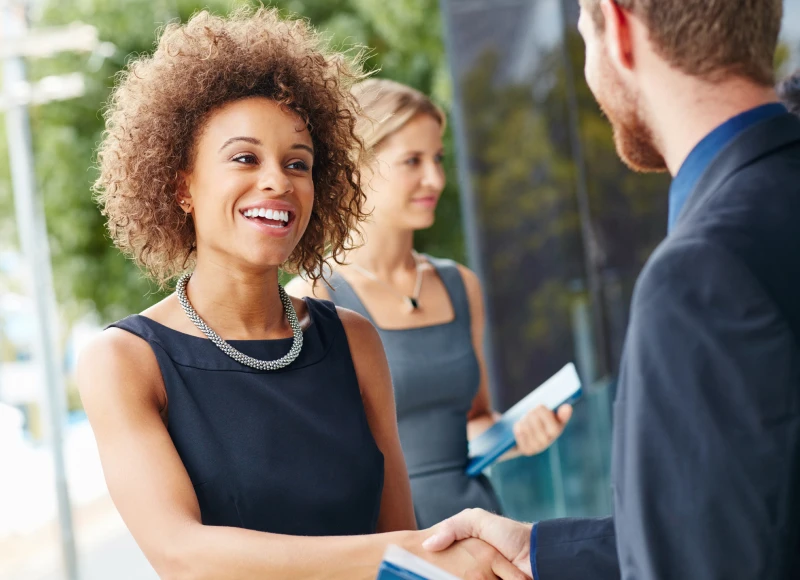 Woman shaking hands with colleague