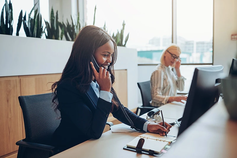Woman sat at desk on the phone