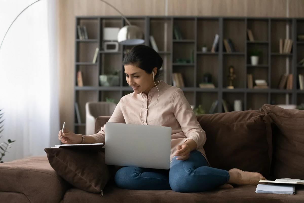 Young Woman Checking Documents On Laptop And Phone