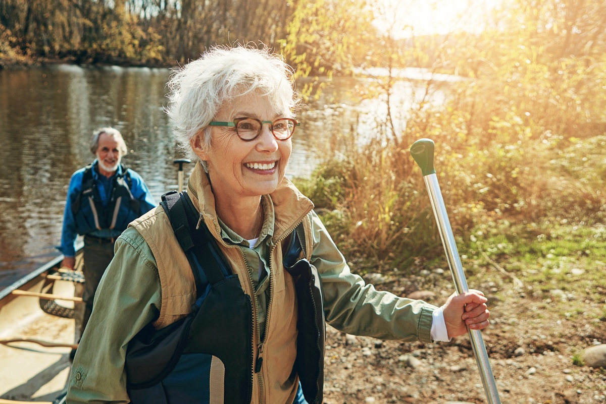 Retired couple enjoying canoeing outdoors