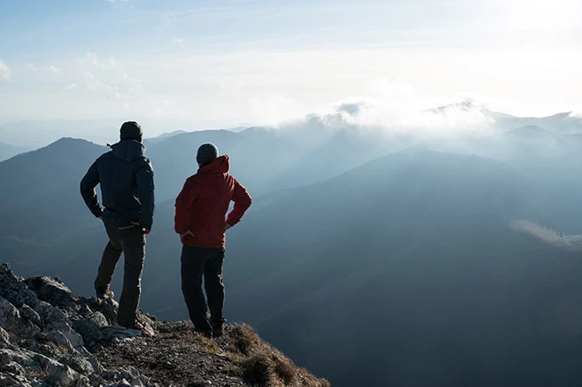 Two men at the top of a mountain