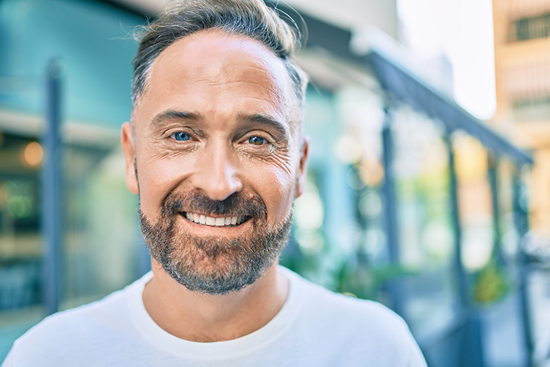 Man smiling on a street