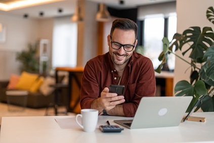 Middle-aged man checking investment performance on his phone