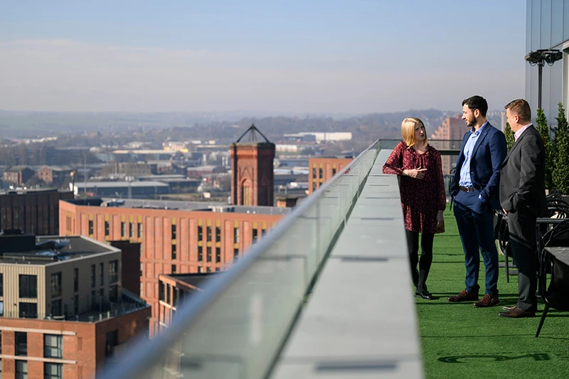 Colleagues talking on roof terrace