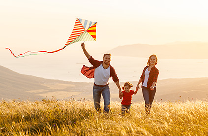 Couple flying a kite with child