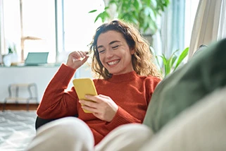 Lady looking at mobile smiling