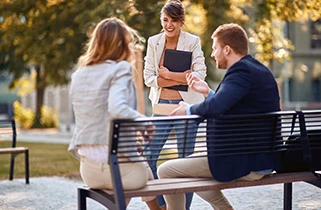 Three people talking in the park