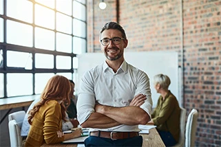 Man in office with arms crossed