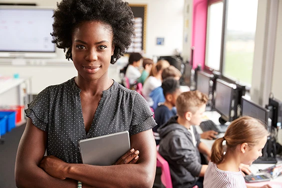 Teacher smiling at front of classroom