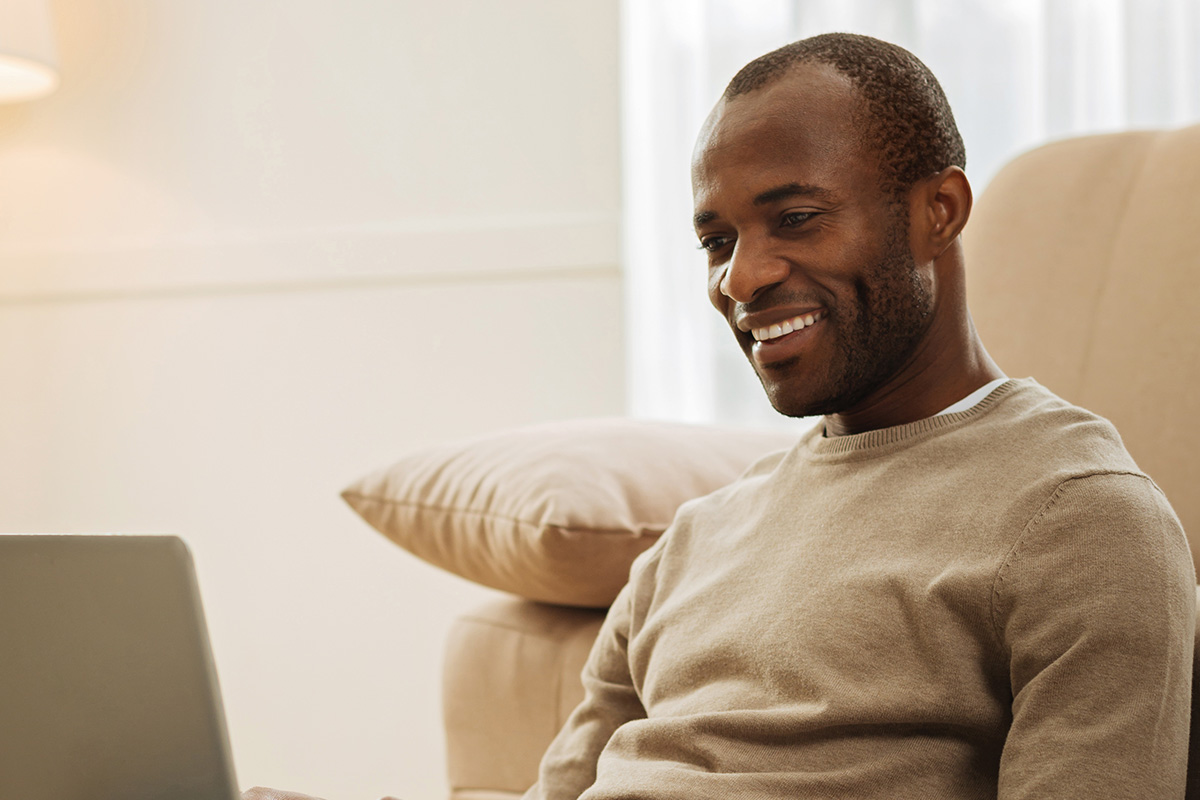 Man sat down on laptop