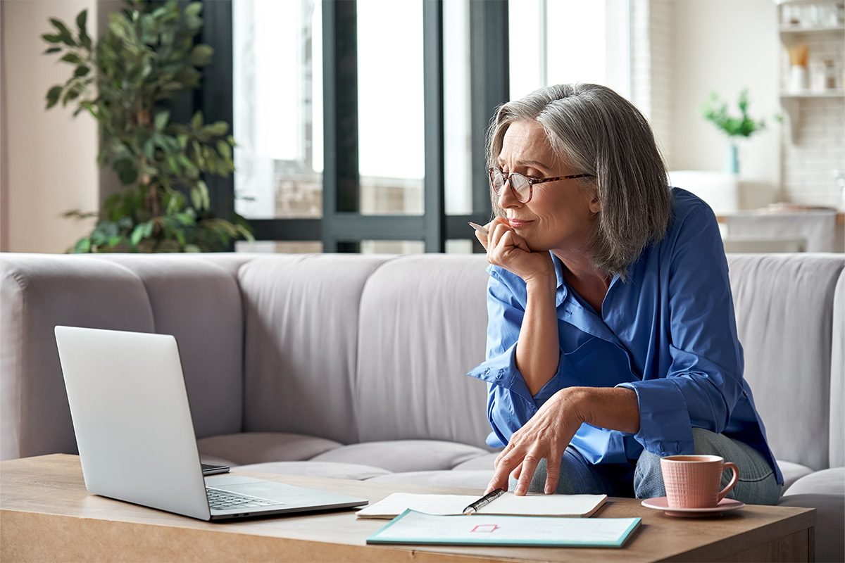 Lady working on a laptop at table