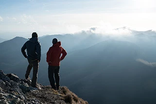 Two men at the top of a mountain