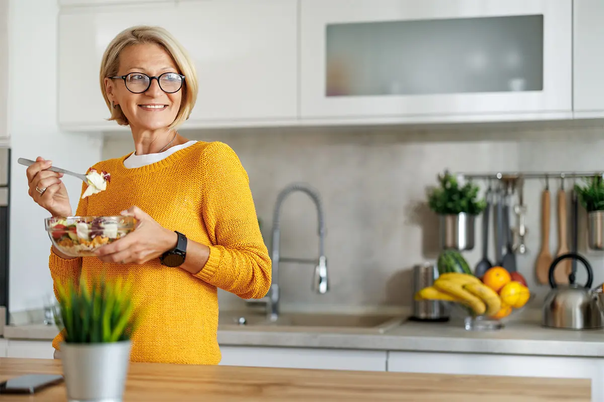 Lady eating breakfast in the kitchen