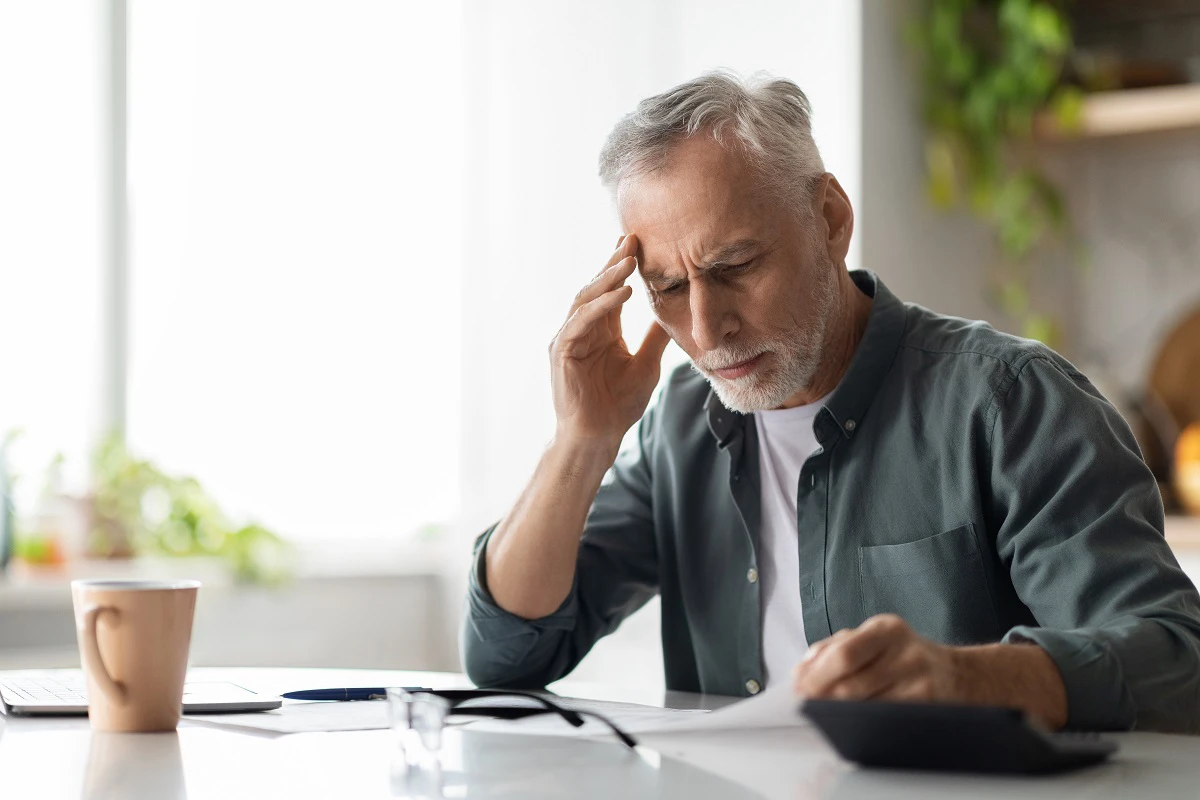 Retired Man Looking At Bills