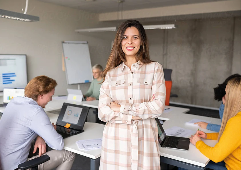 Lady smiling with arms crossed in office
